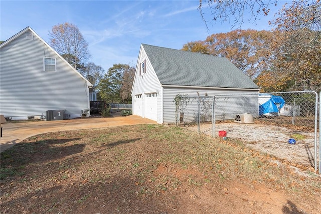 view of side of home featuring a garage and central air condition unit