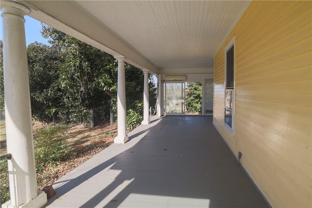 view of patio / terrace featuring a porch and a wall mounted air conditioner