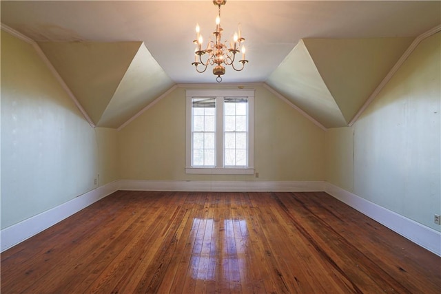 bonus room with lofted ceiling, a notable chandelier, baseboards, and wood finished floors