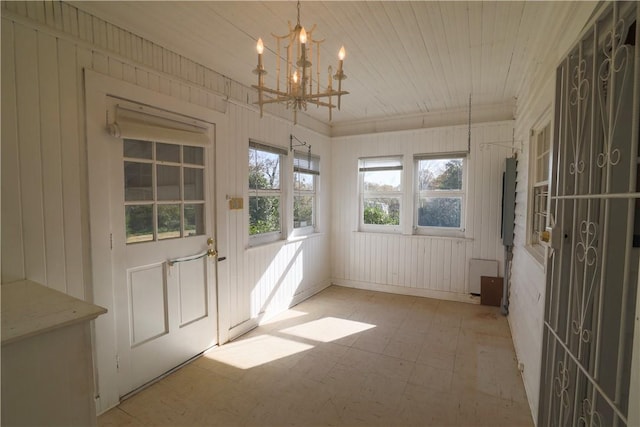 unfurnished sunroom featuring an inviting chandelier and wood ceiling