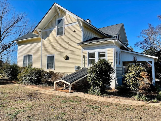 rear view of property with a chimney