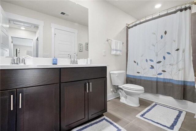 full bathroom featuring tile patterned floors, shower / bath combo with shower curtain, vanity, and toilet