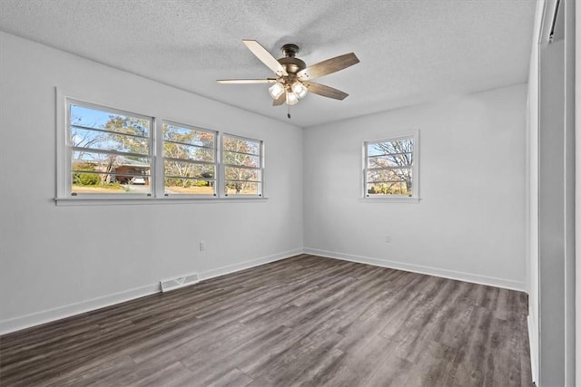 unfurnished room with ceiling fan, dark hardwood / wood-style flooring, and a textured ceiling