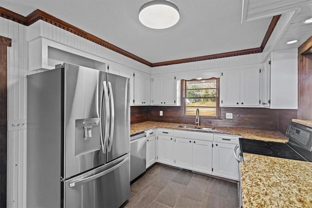 kitchen featuring sink, light stone countertops, ornamental molding, white cabinetry, and stainless steel appliances