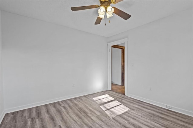 unfurnished room with hardwood / wood-style floors and ceiling fan