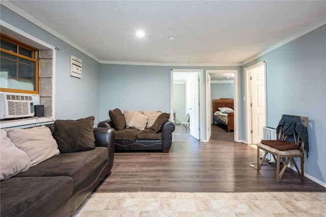 living room with hardwood / wood-style floors, cooling unit, and ornamental molding