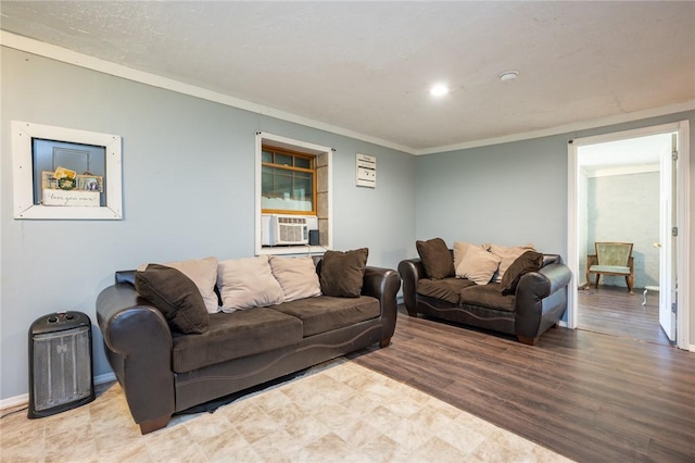 living room with cooling unit, wood-type flooring, and crown molding