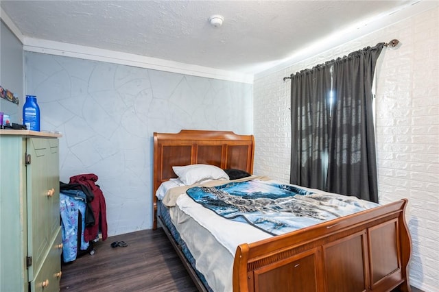 bedroom with a textured ceiling and dark hardwood / wood-style floors