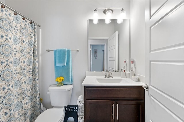 bathroom with a shower with curtain, vanity, and toilet