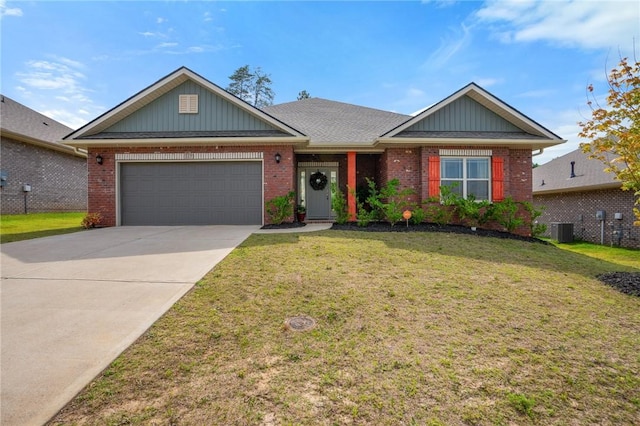 view of front of property with central AC, a front yard, and a garage