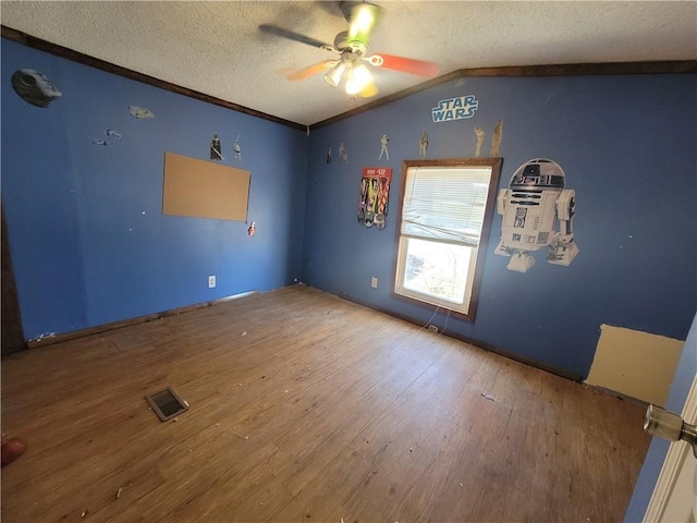 unfurnished room featuring hardwood / wood-style floors, ceiling fan, lofted ceiling, and a textured ceiling