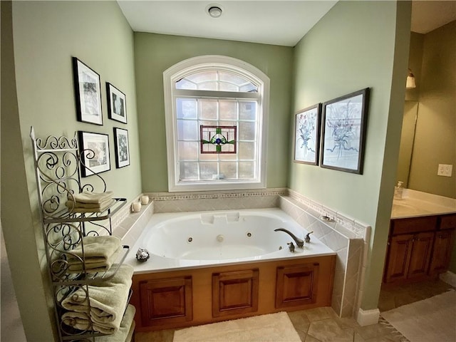 bathroom featuring vanity, tile patterned floors, and a tub