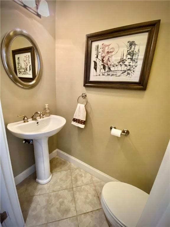 bathroom with toilet and tile patterned floors