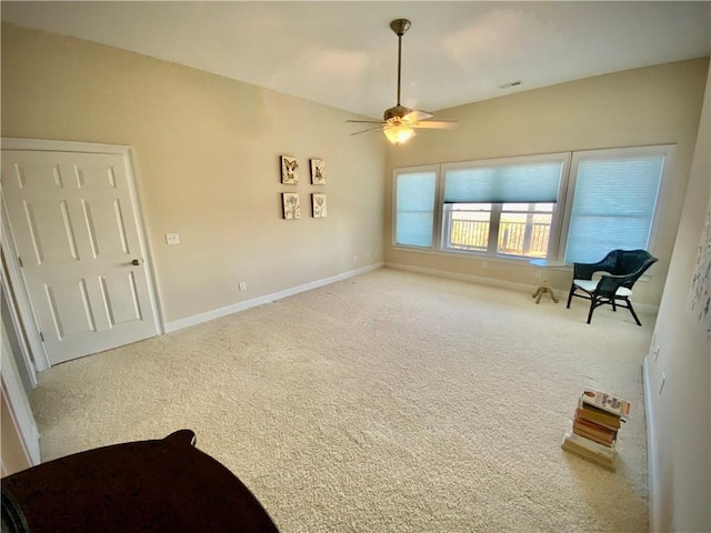 unfurnished room featuring ceiling fan and light carpet