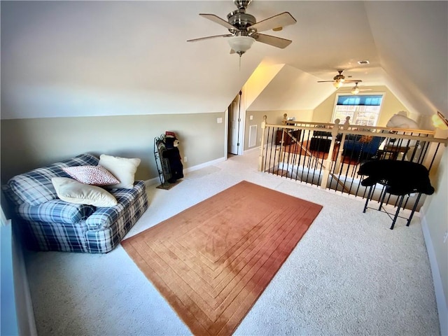 carpeted living room with ceiling fan and vaulted ceiling