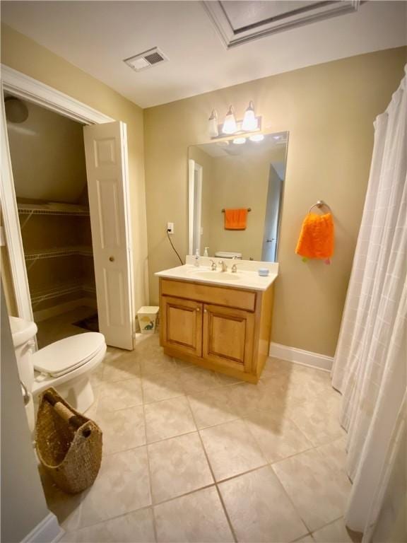 bathroom with tile patterned floors, curtained shower, vanity, and toilet