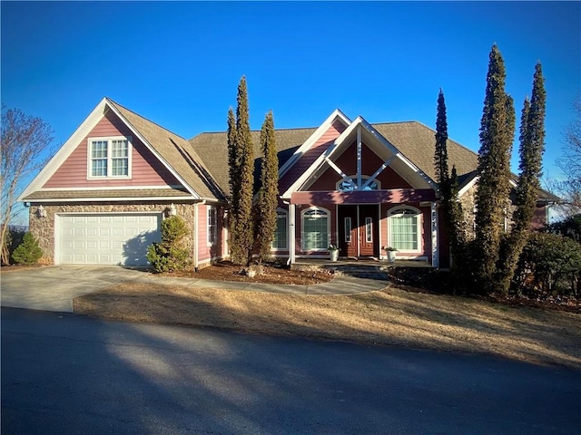 view of front of property featuring covered porch and a garage