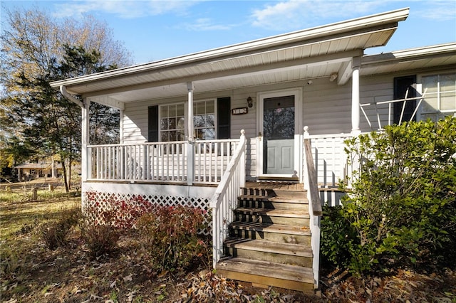 view of exterior entry with covered porch