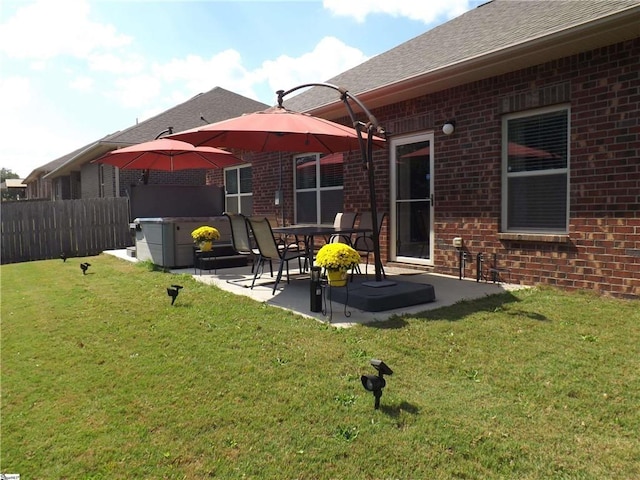 rear view of house featuring a patio area and a yard