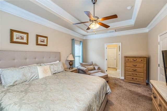 carpeted bedroom featuring crown molding, ceiling fan, and a tray ceiling