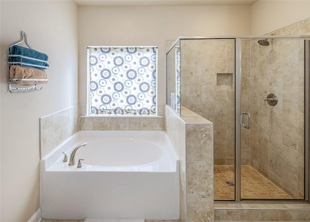 bathroom featuring separate shower and tub