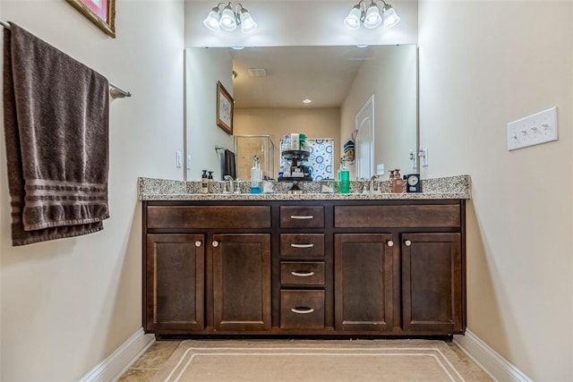 bathroom featuring a shower, tile patterned floors, and vanity