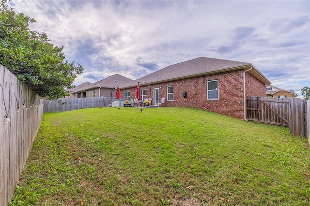 rear view of house with a yard