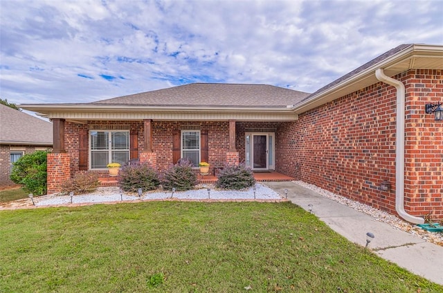 doorway to property featuring a yard