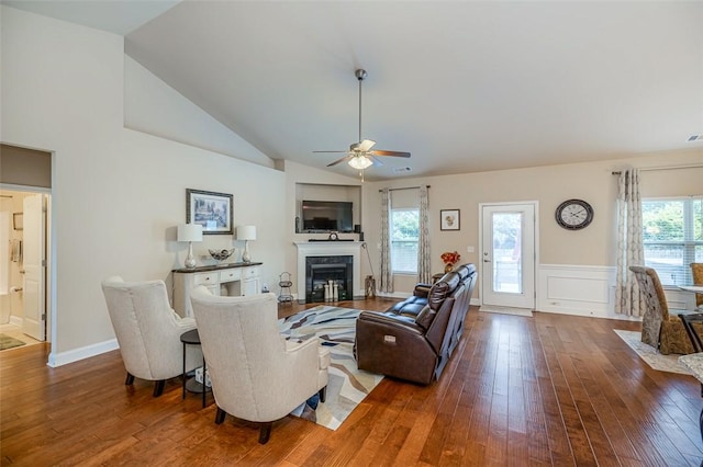 living room featuring wood-type flooring, ceiling fan, and plenty of natural light