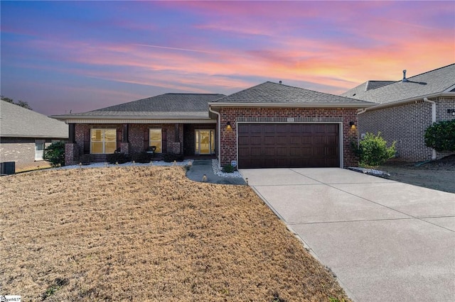 view of front of house with a lawn and a garage