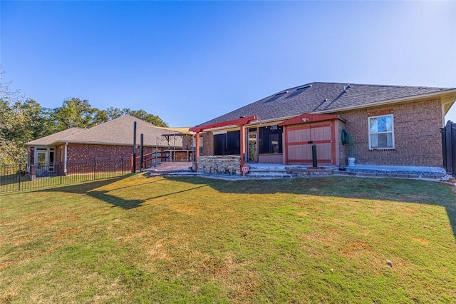 back of house featuring a lawn