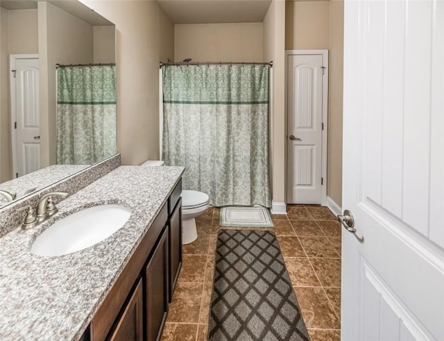 bathroom featuring tile patterned floors, vanity, curtained shower, and toilet