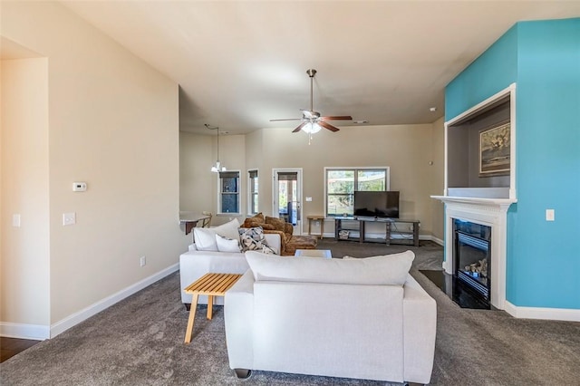 carpeted living room with ceiling fan