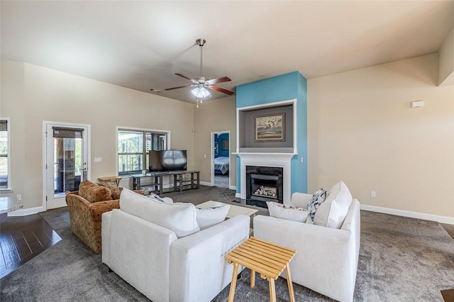 living room with ceiling fan and dark wood-type flooring