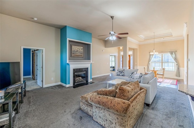 carpeted living room with ceiling fan and crown molding