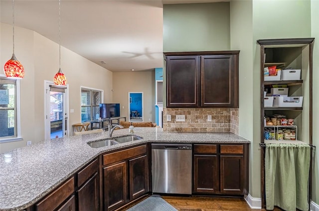 kitchen featuring dishwasher, a healthy amount of sunlight, kitchen peninsula, and sink