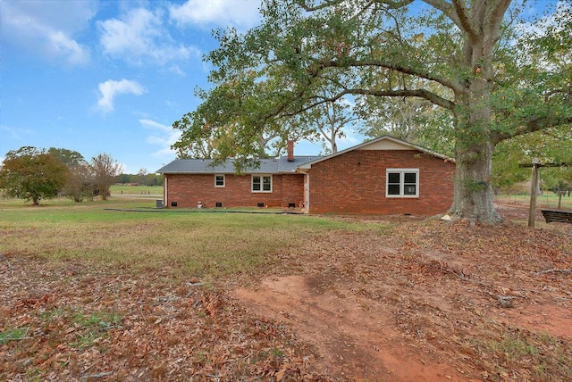 back of house with a lawn