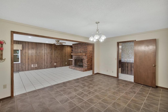 unfurnished living room with tile patterned floors, a brick fireplace, wooden walls, and crown molding