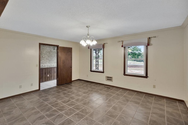 tiled empty room featuring a textured ceiling, crown molding, and a chandelier