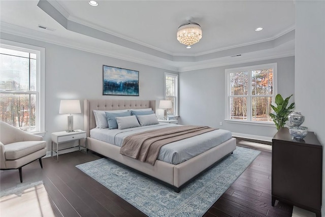 bedroom featuring crown molding, dark wood-type flooring, and multiple windows