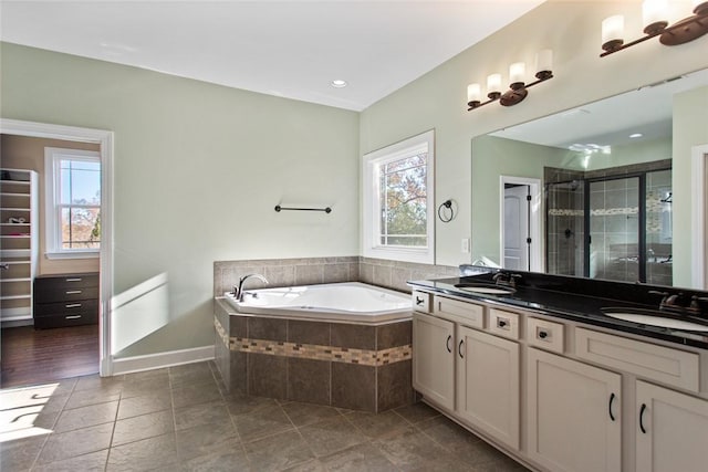 bathroom with tile patterned flooring, vanity, plenty of natural light, and independent shower and bath