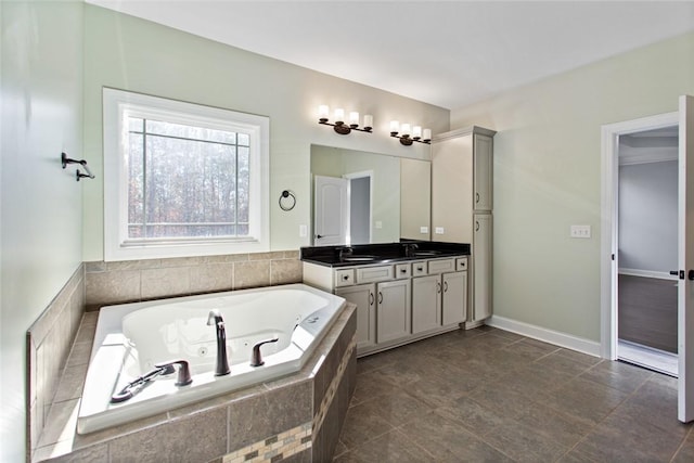 bathroom with vanity and tiled bath