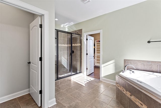 bathroom with plus walk in shower and tile patterned flooring