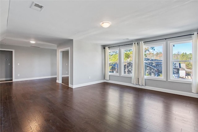 spare room featuring dark hardwood / wood-style floors