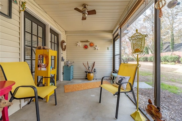 sunroom with ceiling fan and wooden ceiling