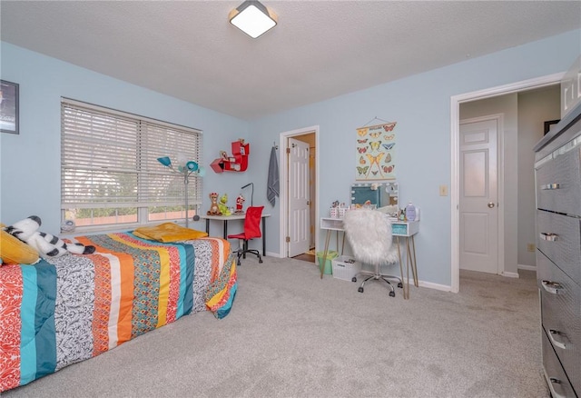 bedroom featuring light carpet and a textured ceiling