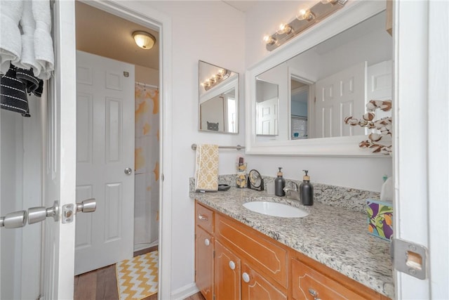 bathroom with vanity, a shower with shower curtain, and hardwood / wood-style flooring