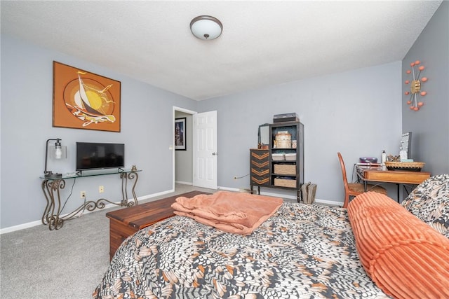 bedroom featuring carpet flooring and a textured ceiling