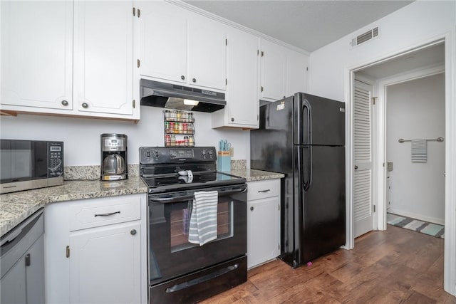 kitchen featuring light stone countertops, dark hardwood / wood-style floors, white cabinetry, and black appliances