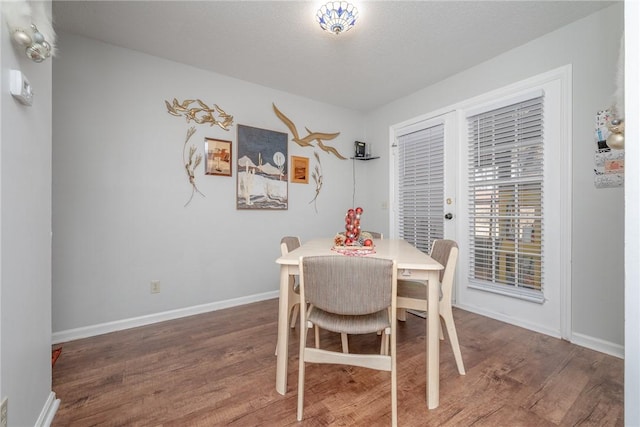 dining area with hardwood / wood-style flooring